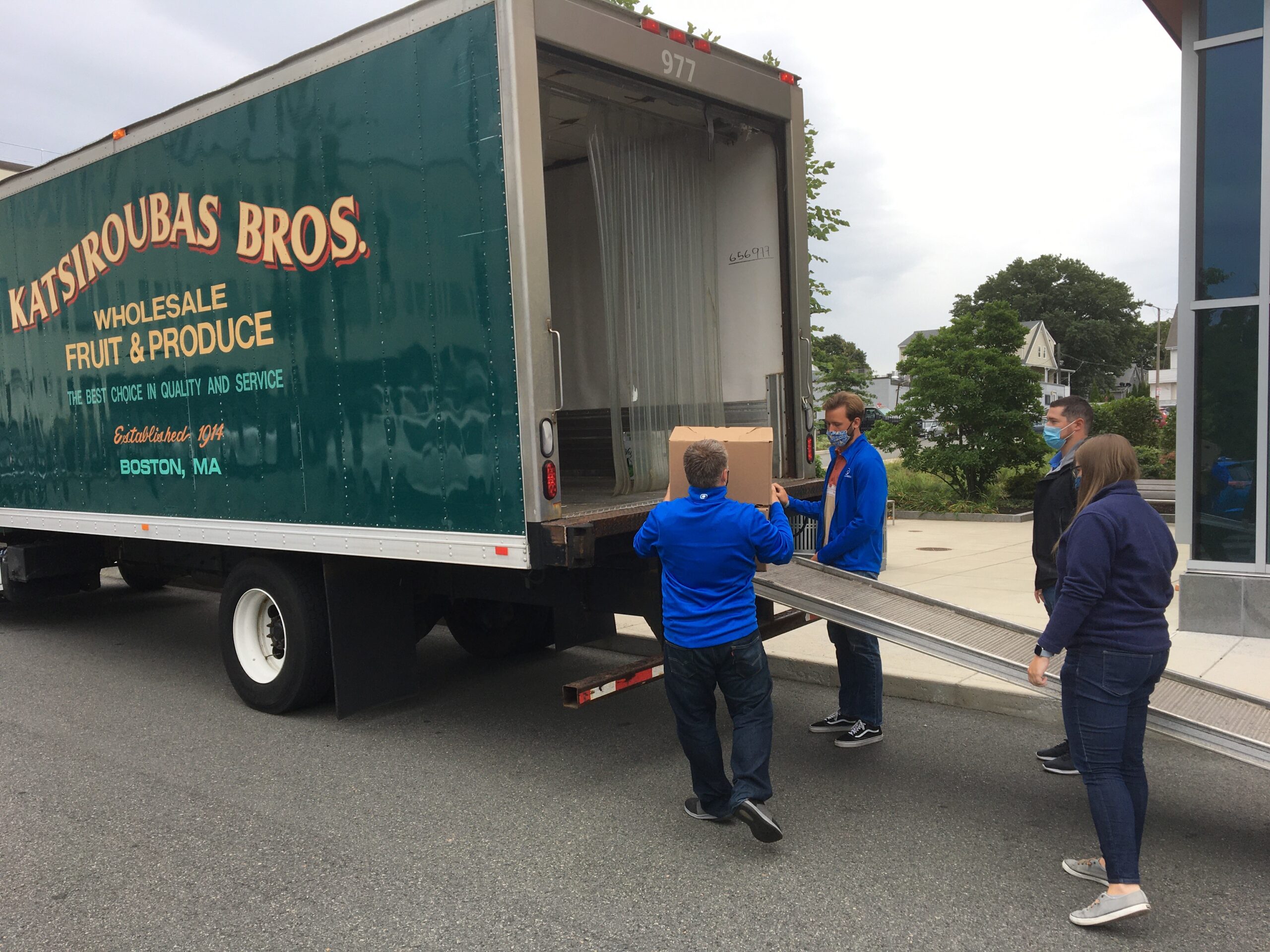 Newburg CPA Team charitable initiatives unloading produce boxes for those in need